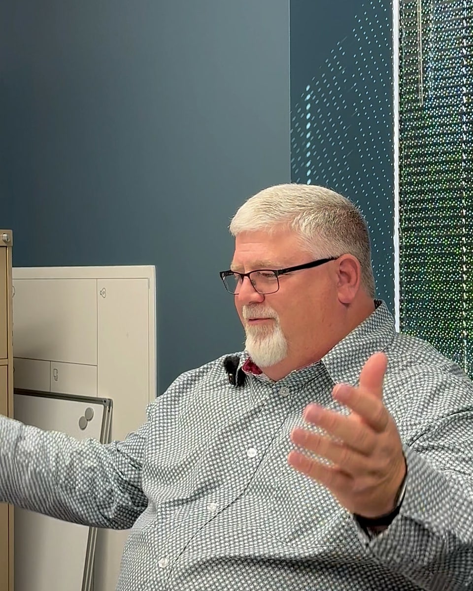 Bill Jurey explaining Medicare options at his office