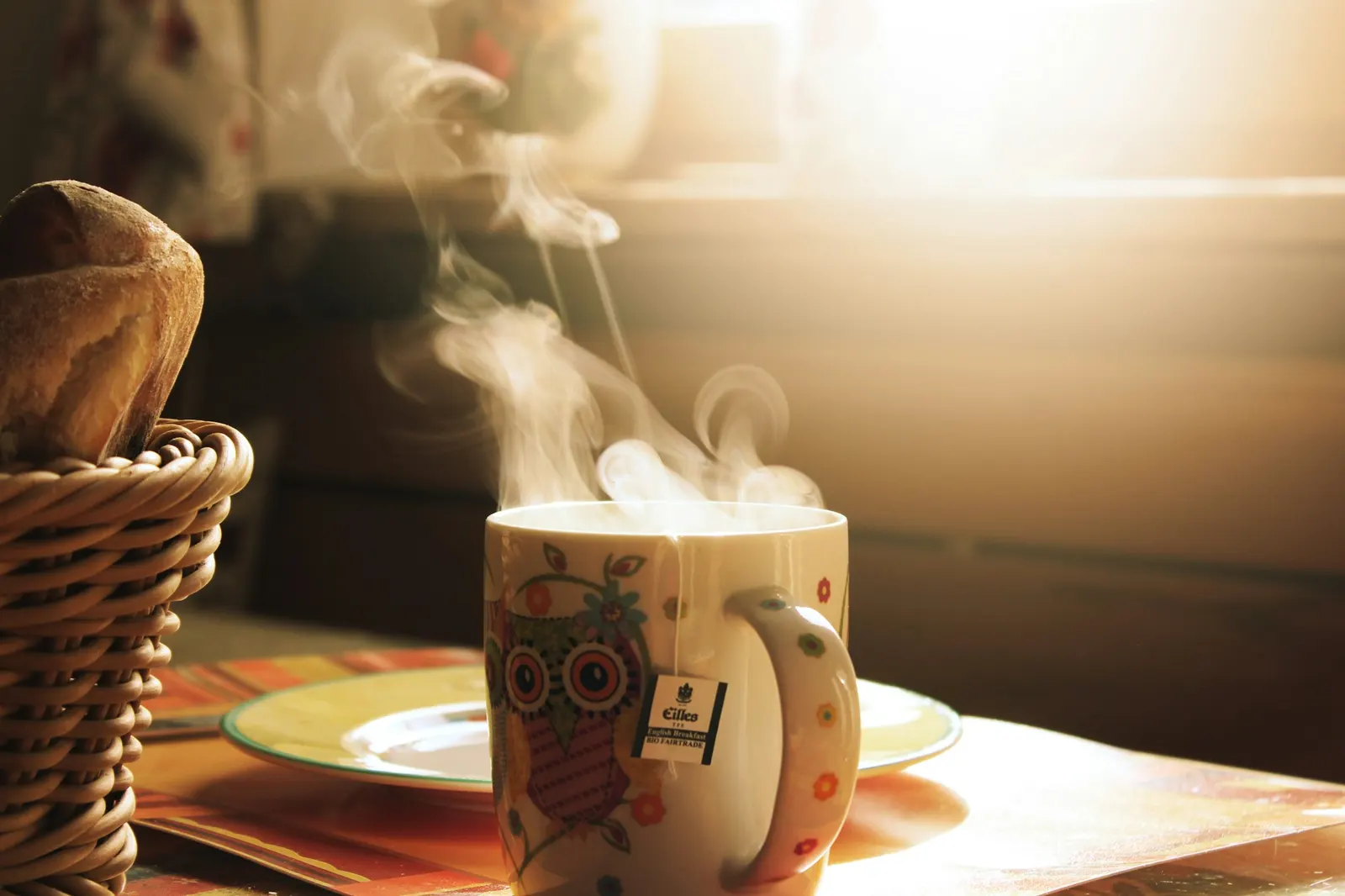 Steaming mug of coffee in warm morning light