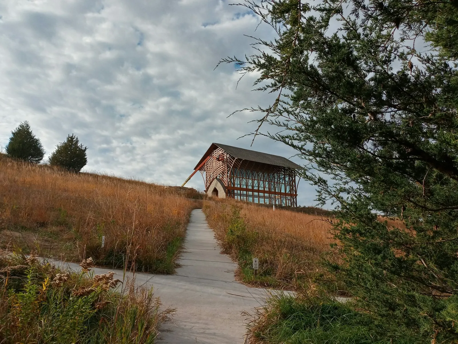 Wooden structure on a grassy prairie hillside